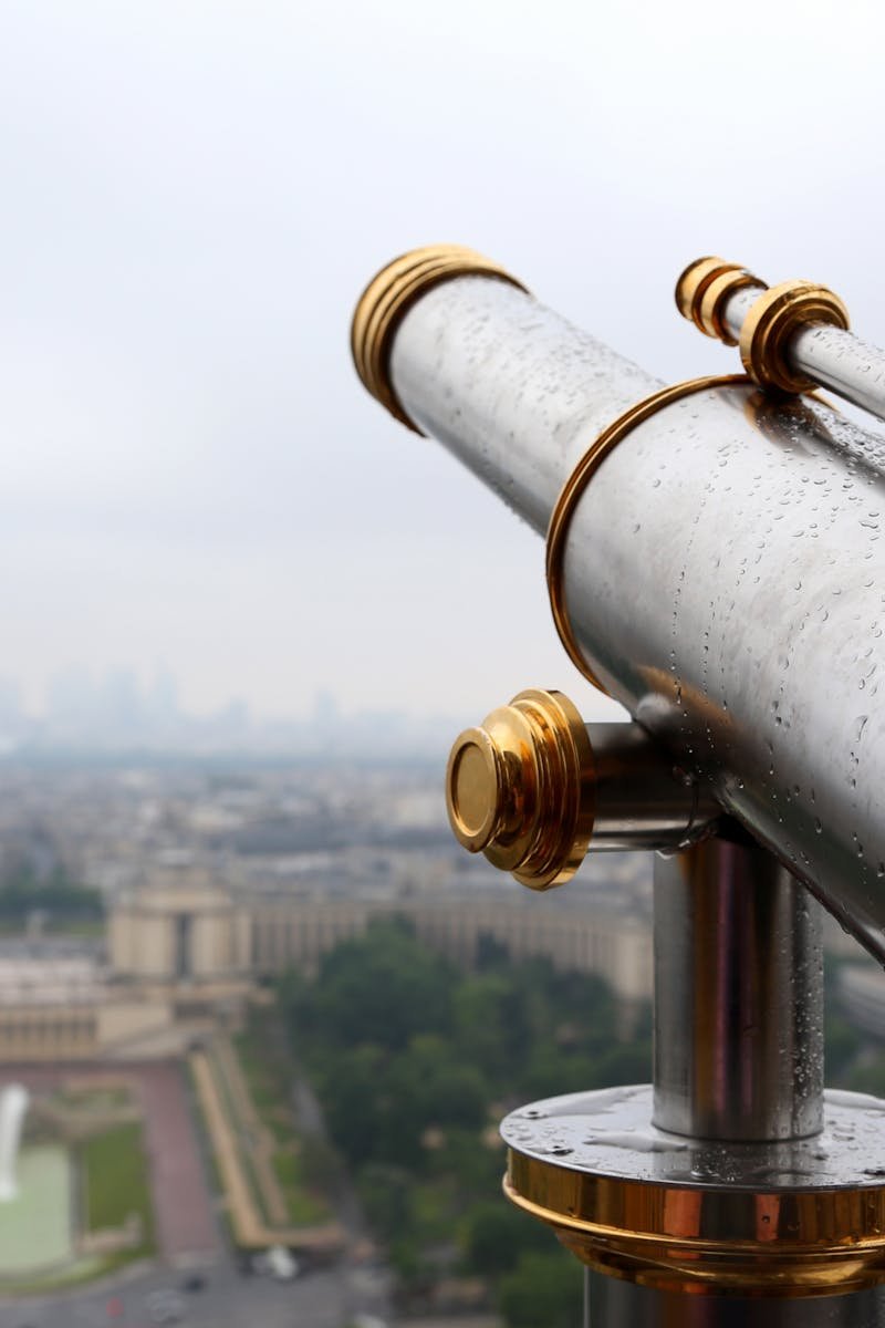 A scenic view of Paris as seen through a telescope on the Eiffel Tower.